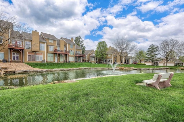 exterior space with a yard, a residential view, and a water view