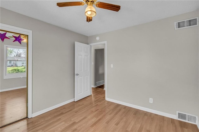 2411 NE 60th St, Gladstone, MO 64118 - unfurnished bedroom featuring light wood-style flooring, visible vents, and baseboards