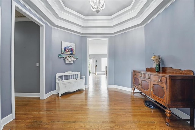 797 NW 1621st Rd, Bates City, MO 64011 - corridor with crown molding, a tray ceiling, wood finished floors, and a notable chandelier