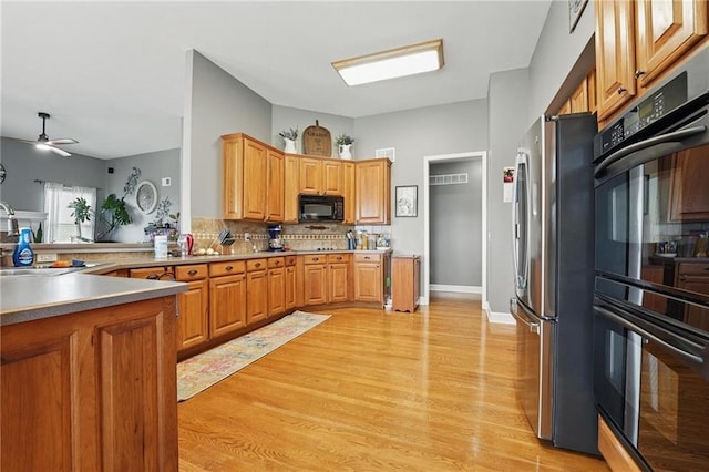 797 NW 1621st Rd, Bates City, MO 64011 - kitchen featuring a ceiling fan, backsplash, a sink, black appliances, and light wood-style flooring