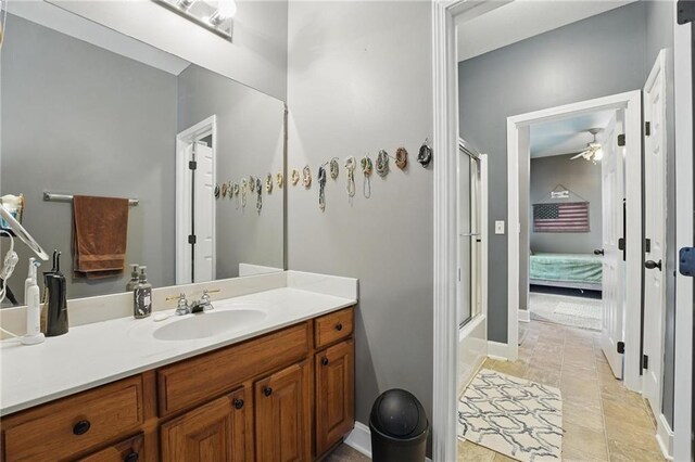 797 NW 1621st Rd, Bates City, MO 64011 - ensuite bathroom with vanity, baseboards, ceiling fan, connected bathroom, and an enclosed shower