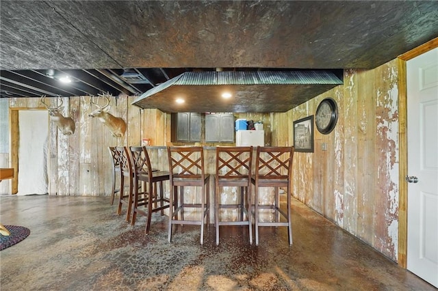 797 NW 1621st Rd, Bates City, MO 64011 - bar featuring a dry bar, concrete floors, and wooden walls