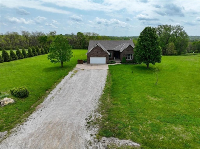797 NW 1621st Rd, Bates City, MO 64011 - ranch-style home with a garage, dirt driveway, a front lawn, and brick siding