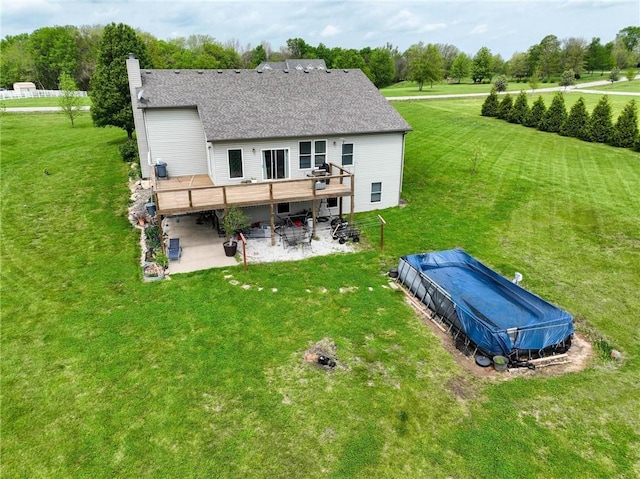797 NW 1621st Rd, Bates City, MO 64011 - back of property featuring a wooden deck, a chimney, a yard, and a patio area