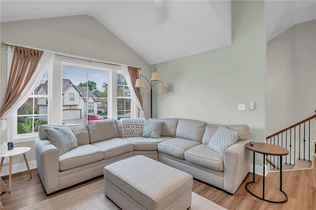 12631 Fountain Lake Cir, Grandview, MO 64030 - living area featuring lofted ceiling and wood finished floors