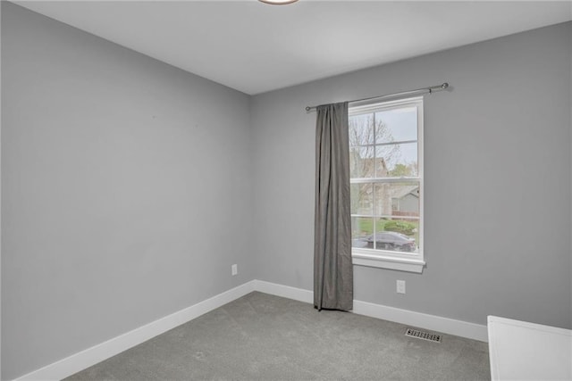 12631 Fountain Lake Cir, Grandview, MO 64030 - spare room featuring baseboards and carpet