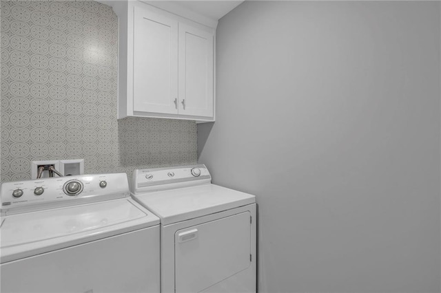 12631 Fountain Lake Cir, Grandview, MO 64030 - laundry room with cabinet space and washer and dryer
