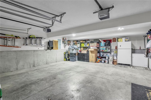 12631 Fountain Lake Cir, Grandview, MO 64030 - garage with freestanding refrigerator, a garage door opener, and refrigerator