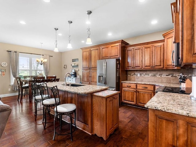 105 Fox Den Ct, Savannah, MO 64485 - kitchen featuring brown cabinetry, a sink, stove, and stainless steel refrigerator with ice dispenser
