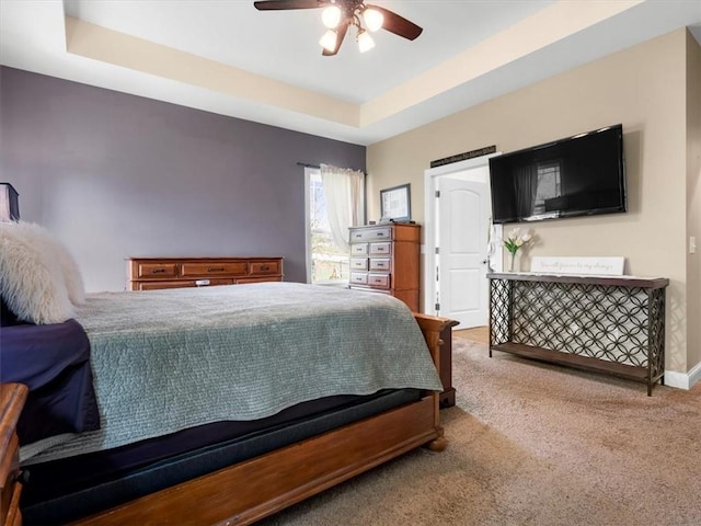 105 Fox Den Ct, Savannah, MO 64485 - carpeted bedroom featuring a tray ceiling, ceiling fan, and baseboards