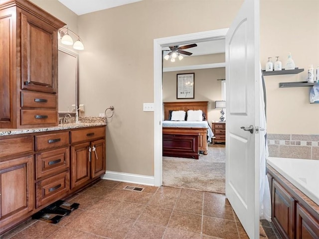 105 Fox Den Ct, Savannah, MO 64485 - ensuite bathroom featuring visible vents, baseboards, a ceiling fan, ensuite bath, and vanity
