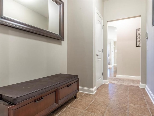 105 Fox Den Ct, Savannah, MO 64485 - hallway featuring arched walkways, light tile patterned flooring, and baseboards