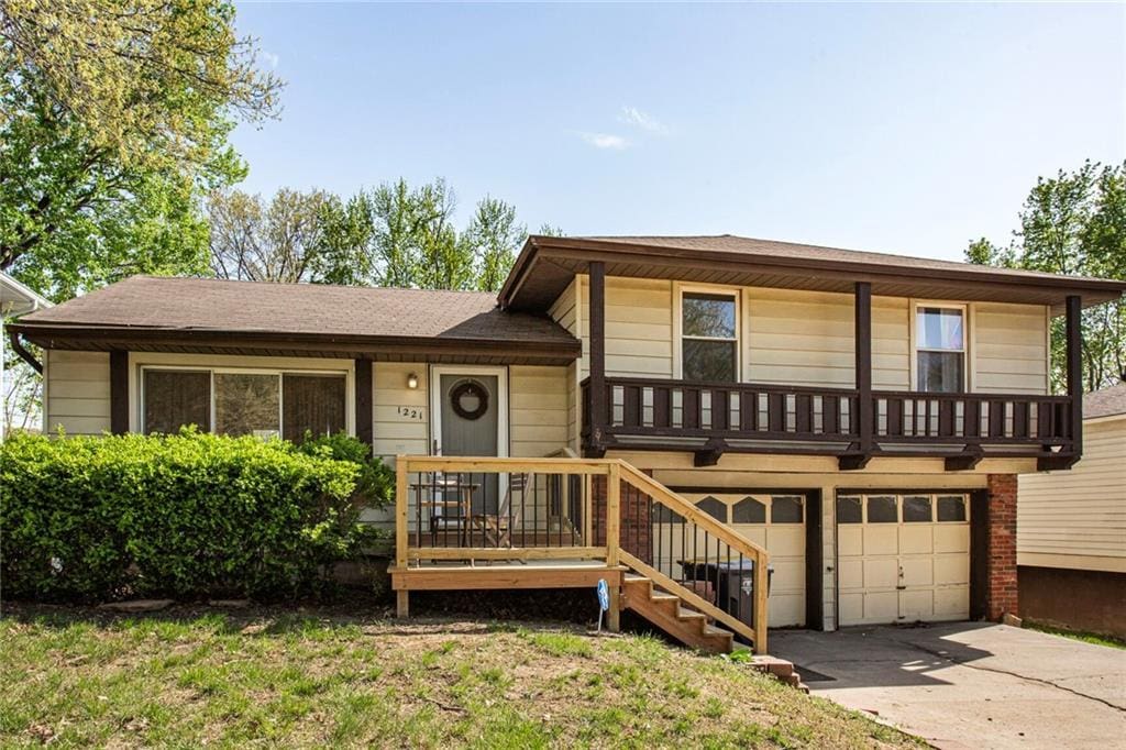 1221 NW 66th Ter, Kansas City, MO 64118 - split level home featuring concrete driveway and a garage
