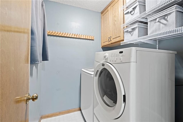 laundry area with a textured ceiling, cabinet space, and independent washer and dryer