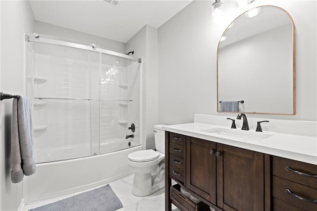 bathroom with toilet, marble finish floor, bath / shower combo with glass door, and vanity