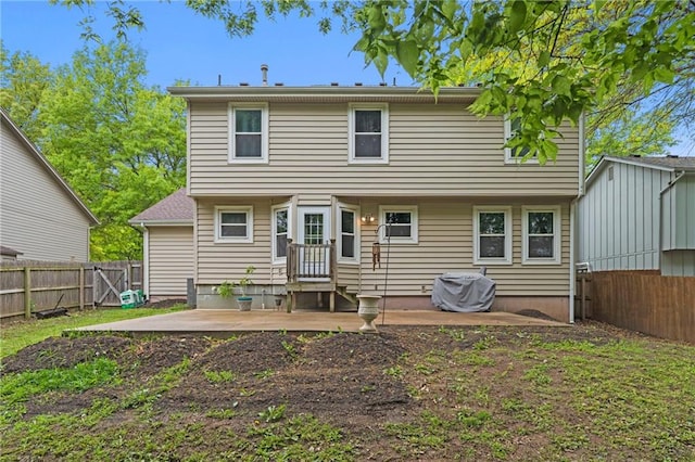 back of property featuring a fenced backyard and a patio area