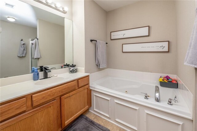 full bathroom with a jetted tub, visible vents, tile patterned flooring, and vanity