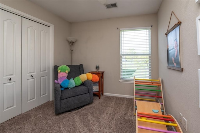 sitting room with baseboards, carpet flooring, and visible vents