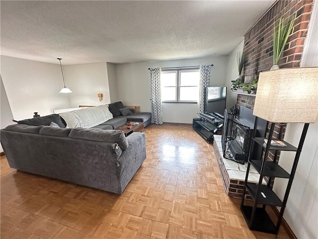 83 Grandview Dr, Warrensburg, MO 64093 - living room featuring a brick fireplace, a textured ceiling, and baseboards