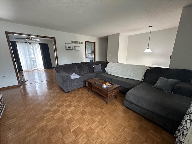 83 Grandview Dr, Warrensburg, MO 64093 - living room with a textured ceiling, ceiling fan, and baseboards