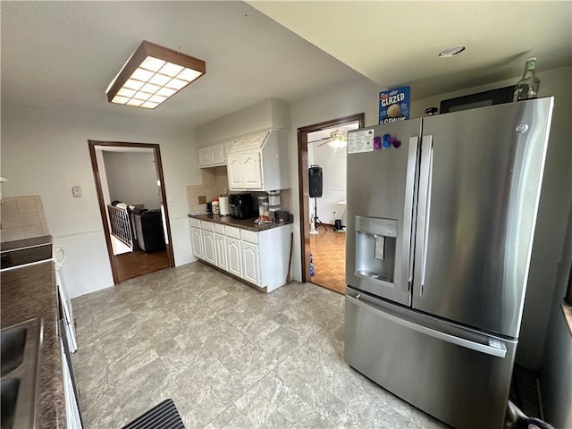83 Grandview Dr, Warrensburg, MO 64093 - kitchen featuring stainless steel fridge, white cabinets, a ceiling fan, and dark countertops