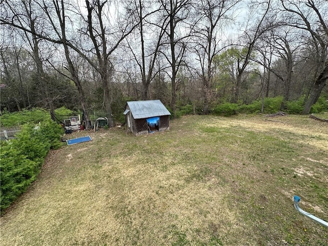83 Grandview Dr, Warrensburg, MO 64093 - view of grassy yard with an outbuilding and a view of trees