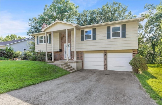 83 Grandview Dr, Warrensburg, MO 64093 - raised ranch with asphalt driveway, a front lawn, and brick siding