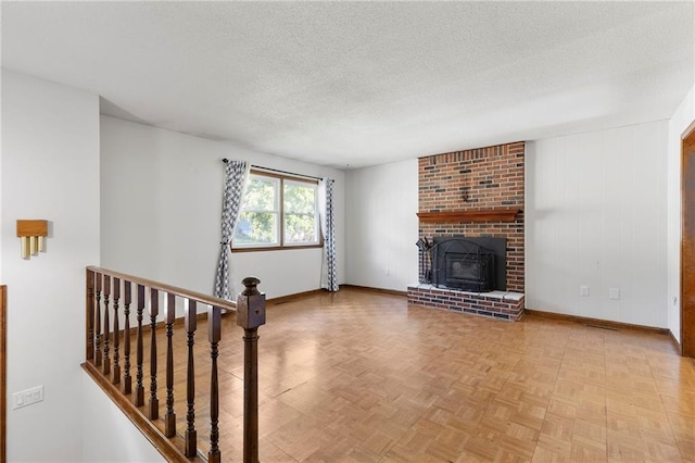 83 Grandview Dr, Warrensburg, MO 64093 - unfurnished living room featuring a textured ceiling and a brick fireplace