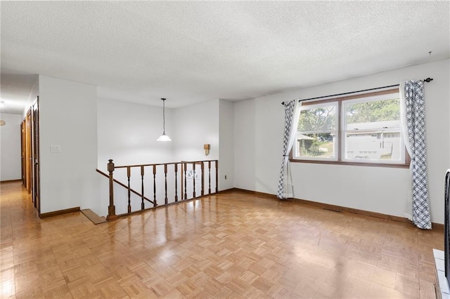 83 Grandview Dr, Warrensburg, MO 64093 - spare room featuring a textured ceiling