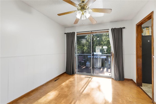 83 Grandview Dr, Warrensburg, MO 64093 - unfurnished room featuring wainscoting, ceiling fan, and a textured ceiling