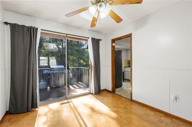 83 Grandview Dr, Warrensburg, MO 64093 - spare room featuring a wainscoted wall and ceiling fan