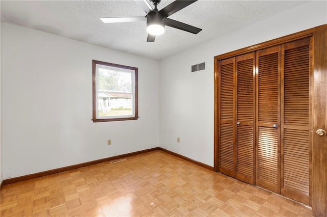 83 Grandview Dr, Warrensburg, MO 64093 - unfurnished bedroom featuring a closet, a textured ceiling, and a ceiling fan