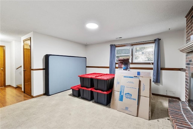 83 Grandview Dr, Warrensburg, MO 64093 - rec room featuring carpet floors, a fireplace, and a textured ceiling
