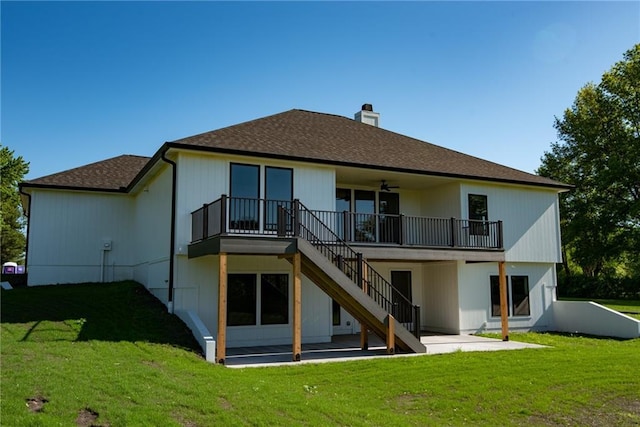 rear view of house with a patio, a chimney, a lawn, stairway, and ceiling fan