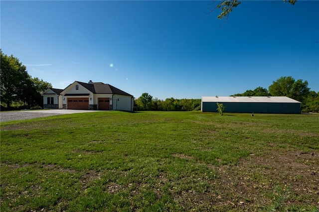 view of yard with driveway and a garage