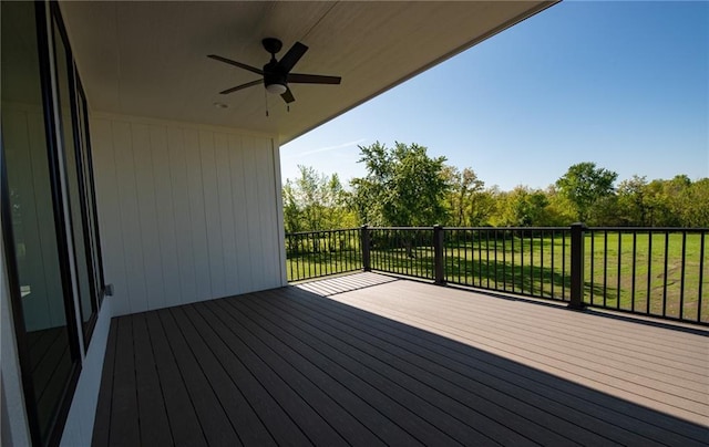 deck with a yard and ceiling fan