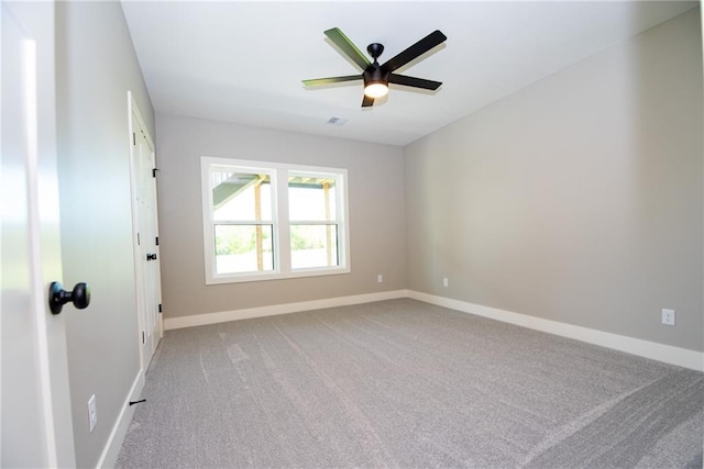 spare room featuring ceiling fan, carpet, baseboards, and visible vents
