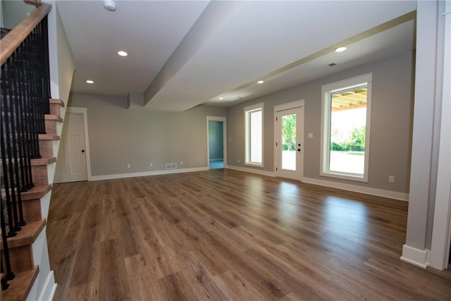 unfurnished living room featuring recessed lighting, baseboards, visible vents, wood finished floors, and stairway