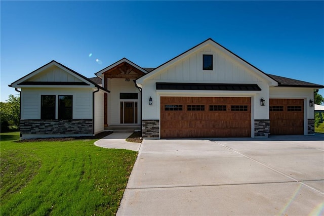 modern farmhouse with an attached garage, board and batten siding, and stone siding