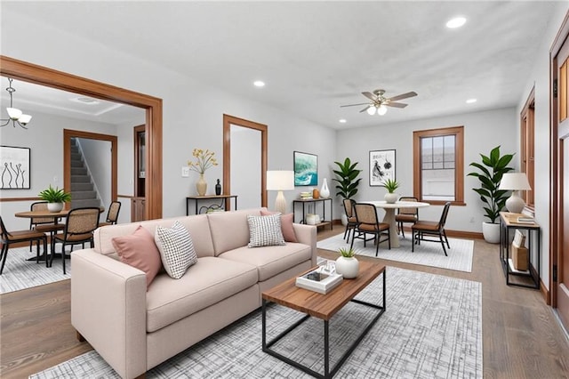 living room with stairway, a ceiling fan, wood finished floors, and recessed lighting