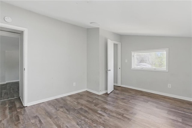 unfurnished room with baseboards and wood finished floors