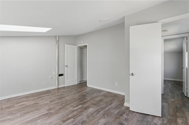 basement featuring wood finished floors and baseboards