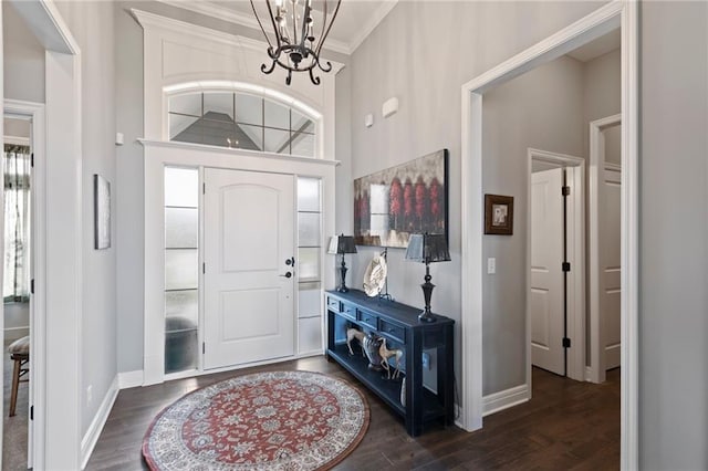 6840 Belmont Dr, Shawnee, KS 66226 - entryway featuring a high ceiling, dark wood-style floors, an inviting chandelier, ornamental molding, and baseboards