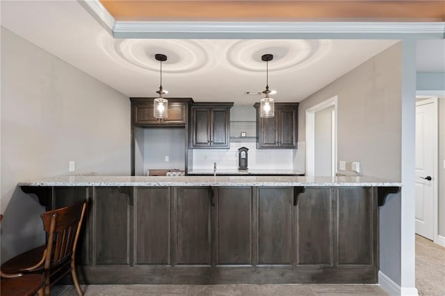 6840 Belmont Dr, Shawnee, KS 66226 - bar with a tray ceiling, a sink, baseboards, decorative backsplash, and hanging light fixtures