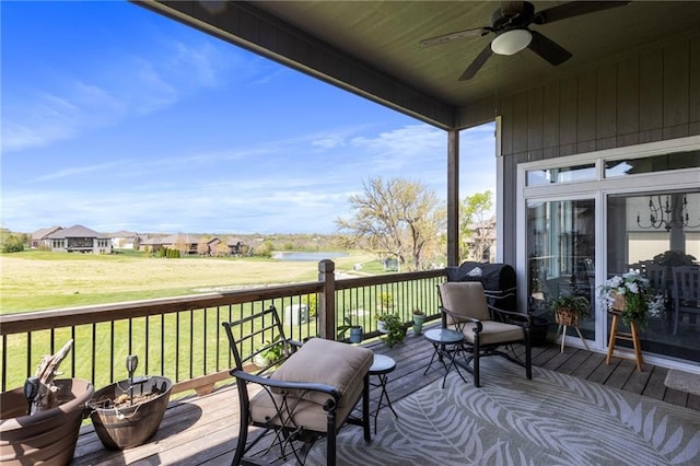 6840 Belmont Dr, Shawnee, KS 66226 - deck featuring ceiling fan, a lawn, and a water view