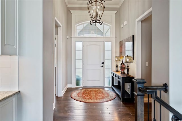 6840 Belmont Dr, Shawnee, KS 66226 - foyer entrance with a chandelier, dark wood finished floors, and crown molding