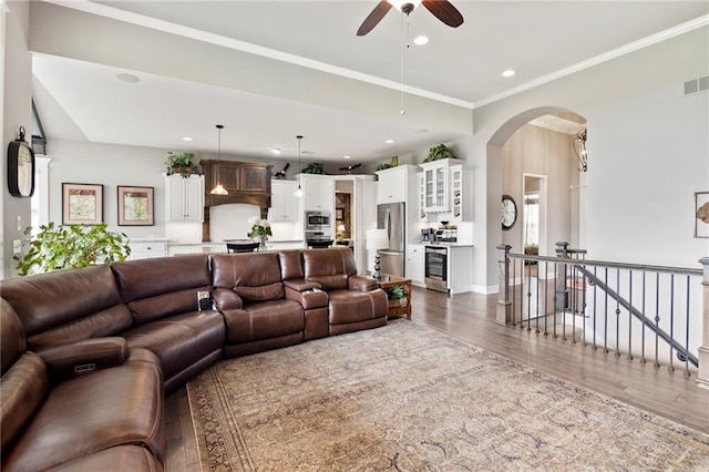6840 Belmont Dr, Shawnee, KS 66226 - living room with beverage cooler, wood finished floors, ceiling fan, arched walkways, and recessed lighting
