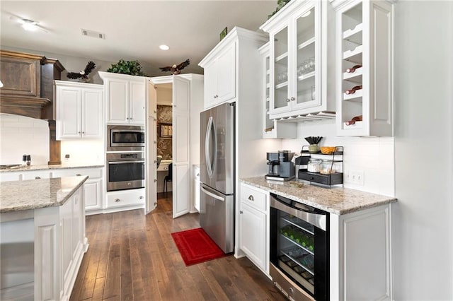6840 Belmont Dr, Shawnee, KS 66226 - kitchen featuring stainless steel appliances, beverage cooler, white cabinets, dark wood-type flooring, and recessed lighting