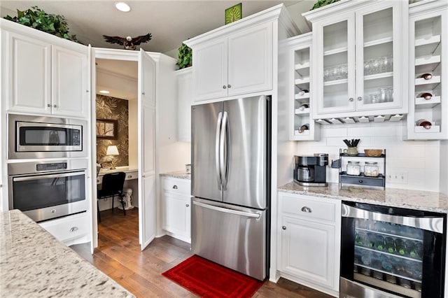 6840 Belmont Dr, Shawnee, KS 66226 - kitchen featuring appliances with stainless steel finishes, beverage cooler, white cabinets, and recessed lighting