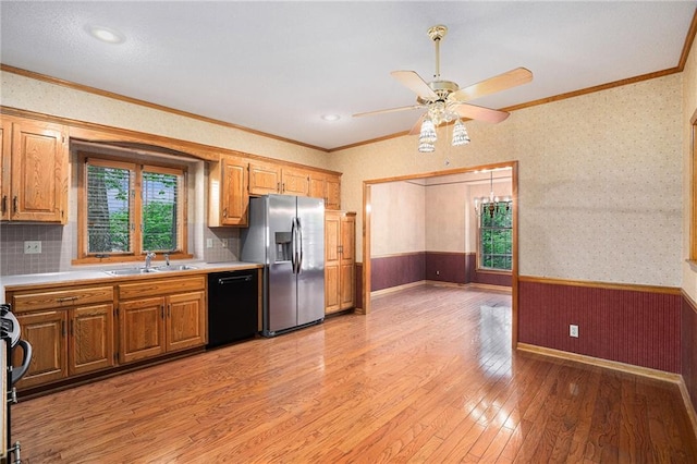 kitchen featuring a sink, dishwasher, stainless steel refrigerator with ice dispenser, and ornamental molding